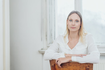 Young woman sitting staring at the camera
