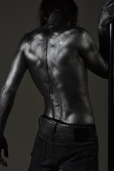 Fototapeta na wymiar back treatment of muscular man at pole. back health and power