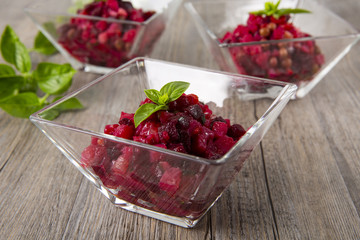 Salad from the beet. Vinaigrette is a traditional Russian salad made from beets and vegetables. Three bowls with salad.