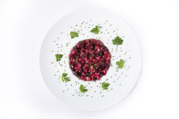 Salad from the beet. Vinaigrette is a traditional Russian salad made from beets and vegetables. The background is white. Top view. Copy space.