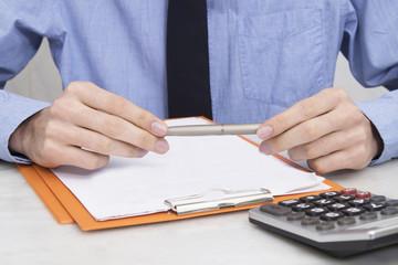 Fototapeta premium hands of business man or banker with pen and documents