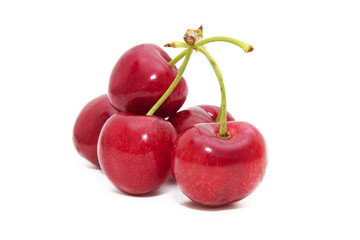ripe red cherries isolated in white background