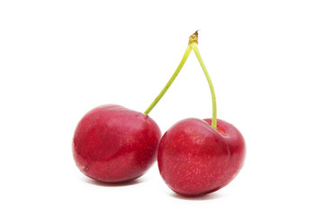 ripe red cherries isolated in white background