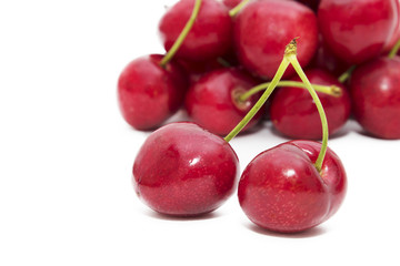ripe red cherries isolated in white background