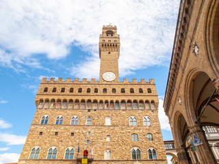 Obraz premium Bottom view of Pallazo Vecchio, Old Palace - Town Hall, with high bell tower, Piazza della Signoria, Florence, Tuscany, Italy.