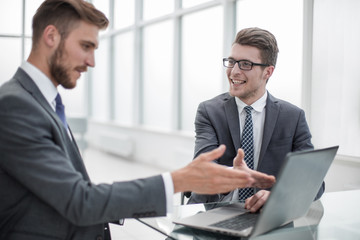 close up.colleagues discussing information sitting at the Desk