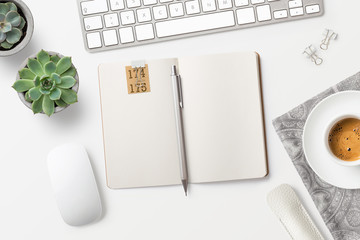 modern minimalist workspace / desktop with blank open notebook, coffee, office supplies and...