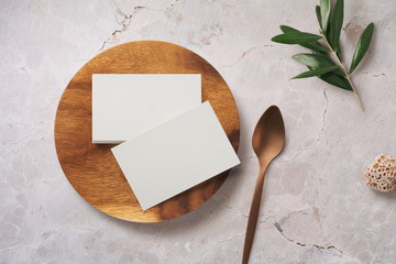 minimalist food or restaurant related branding mock-up with stack of business cards on a wooden plate