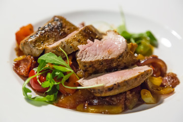 Tasty steak with potato and grilled vegetables on white plate. Close up