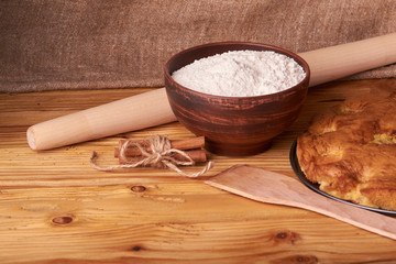 apricot pie and a bowl with flour and other ingredients and tools table