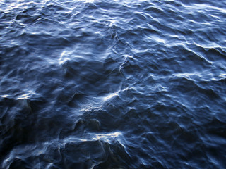 Fototapeta premium Blue water surface, light waves with sun flares, may be used as background or texture