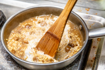 Preparation of risotto with mushrooms in the restaurant kitchen.