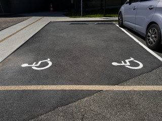 A picture on the asphalt indicates a place for parking disabled people