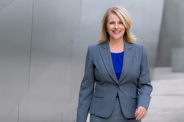 Commercial middle aged model executive in a suit, showing strong confidence and self esteem