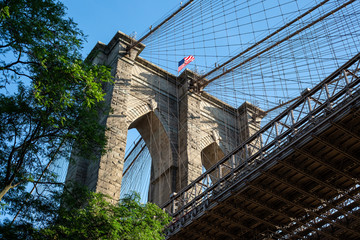 Fototapeta premium New York City / USA - JUN 25 2018: Looking up view of Brooklyn Bridge at sunrise