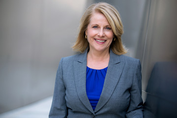 Close up headshot of a 50's likable cheerful CEO entrepreneur business woman