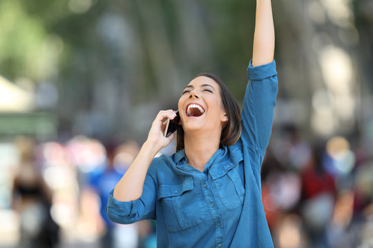 Excited woman receiving good news on the phone