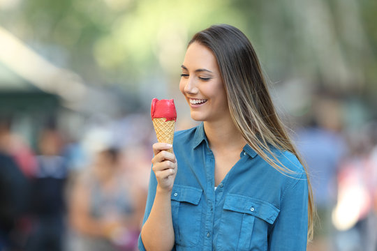 Happy woman holding an ice cream