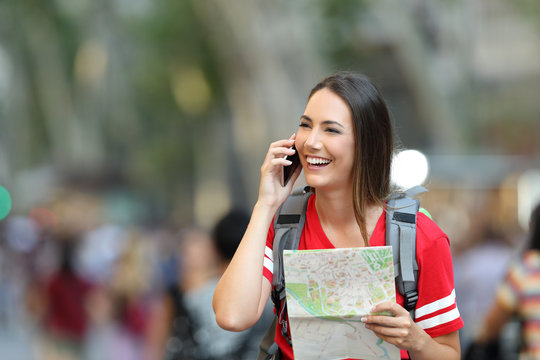 Teenage tourist talking on phone in the street