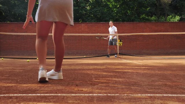 Back view of girl legs practicing ball return, racket sport