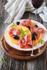 Parma ham with melon and wineglass