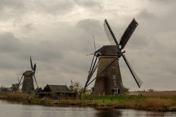 Fototapeta na wymiar Windmills on a Dark, Gloomy and Stormy Spring Day