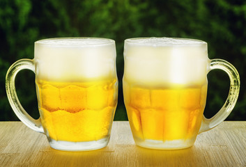 Two glasses of beer on wooden table