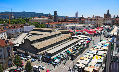 Porta Palazzo old traditional market in Turin, Italy, aerial view with cityscape