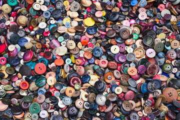 stack of colorful buttons for sale at the market