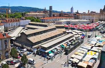 Porta Palazzo old traditional market in Turin, Italy, aerial view with cityscape