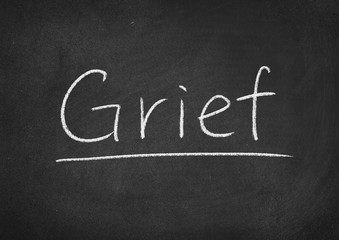 grief concept word on a blackboard background