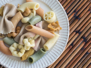 Overhead view of cooked pasta in assorted variety on a plate