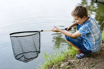 Boy fishing with a net