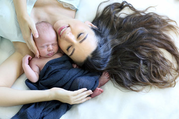 sleeping newborn baby with a mother
