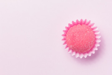 Bicho de pe is a strawberry flovoured brazilian candy. Children birthday party sweet. Top view of candy on pink background.