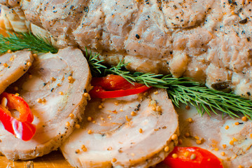 Pork lard with garlic, pepper and herbs on a wooden board