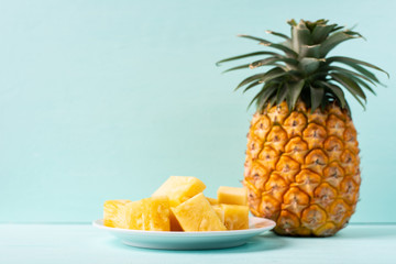 Ripe pineapple on green background, tropical fruit