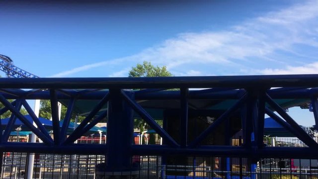 Blue Roller Coaster rides past camera