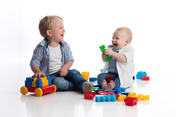 Toddler Boy and his Baby Brother Playing Together
