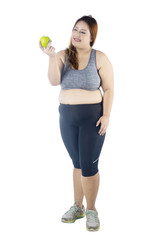 Beautiful fat woman holding fresh apple