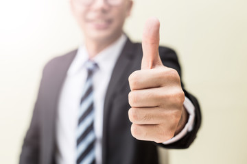 Business man showing thumbs up hand good sign feeling so proud and happiness,Selective focus