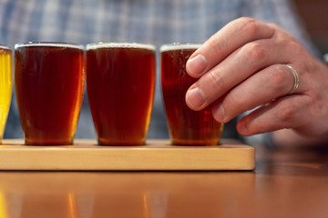 Closeup of man tasting craft beer samples