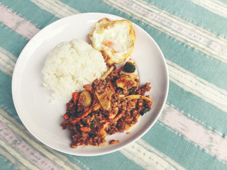 fried minced pork with tomato chili dip and vegetable in white plate with rice and fried egg and Tomato Chili Dip. Thai style food.