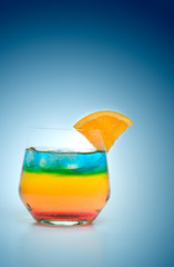 Multi Colored Cocktail Drink on Blue Background