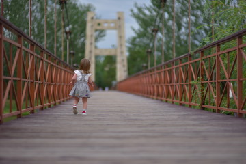 Cute littlу baby girl walks runs smiley and laugh. Happiness of childhood