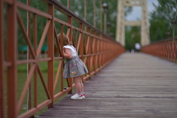 Obraz na płótnie Canvas Cute littlу baby girl walks runs smiley and laugh. Happiness of childhood