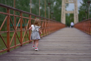 Cute littlу baby girl walks runs smiley and laugh. Happiness of childhood