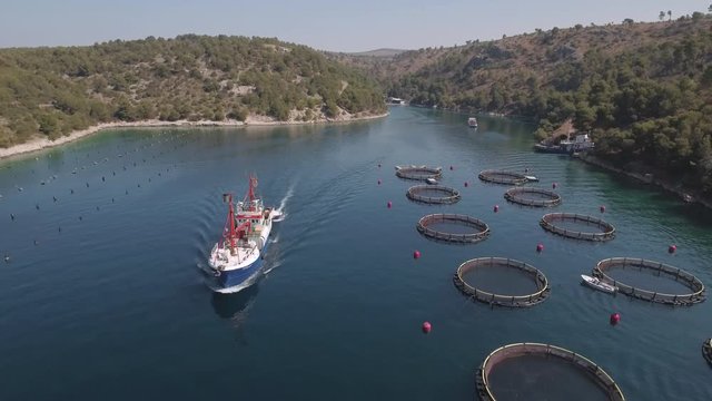 Aerial view of fish farm with cargo ship - Adriatic sea, Croatia