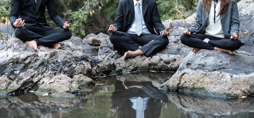 Meditation of business people in nature environment for benefits.