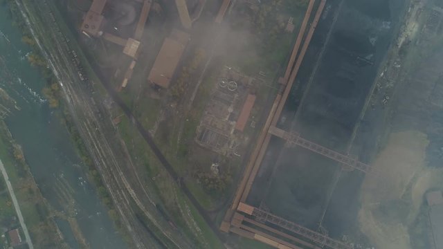 Overhead aerial view of chimneys of steel producing factory billowing toxic smoke in Zenica, Bosnia, Europe